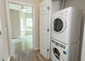Thumbnail 12 of 12 - a white washer and dryer in a white laundry room