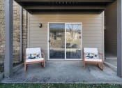 Thumbnail 17 of 28 - two chairs sit on a patio in front of a door at Stonewater Apartments, Louisville, KY 40241