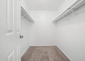 Thumbnail 6 of 14 - a walk in closet in a home with white walls and a carpet at Hampton in Highland Apartments, Highland, IN, 46322