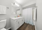 Thumbnail 4 of 14 - a bathroom with a sink toilet and a shower at Hampton in Highland Apartments, Highland, Indiana