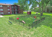 Thumbnail 13 of 14 - a fenced in dog park in the middle of a yard at Hampton in Highland Apartments, Indiana, 46322