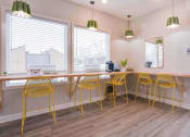 Thumbnail 25 of 28 - a long table with yellow chairs and a mirror on the wall at Stonewater Apartments, Louisville Kentucky