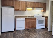 Thumbnail 18 of 20 - a kitchen with white appliances and wooden cabinets