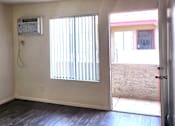 Thumbnail 19 of 20 - an empty room with a window and an air conditioner