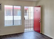 Thumbnail 16 of 20 - apartment entry way with a red door and window