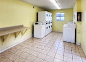 Thumbnail 4 of 20 - Common area laundry facility with counter space