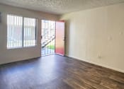 Thumbnail 17 of 20 - a living room, facing the main entry with a red door and window