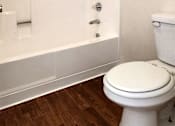 Thumbnail 11 of 20 - a bathroom with a toilet and a combination shower/bathtub