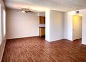 Thumbnail 5 of 20 - a bedroom with a ceiling fan and wood laminate floors