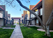 Thumbnail 3 of 20 - a walkway between two buildings on a sunny day