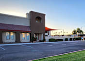 Thumbnail 1 of 20 - Lush green lawn in front of the leasing office at sunrise