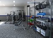 Thumbnail 25 of 27 - A gym with a variety of equipment including treadmills, weight racks, and exercise balls.