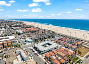 Thumbnail 62 of 64 - A beachfront city with a clear blue sky and ocean.