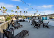 Thumbnail 32 of 64 - Deck with BBQ and chairs at Ocean Breeze Terrace Apartment, California