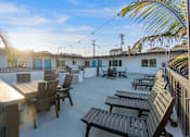 Thumbnail 30 of 64 - A sunny day at the outdoor seating area of a restaurant at Ocean Breeze Terrace Apartment, Huntington Beach, California