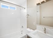Thumbnail 7 of 10 - a bathroom with a tub sink and shower and a mirror at Huntington Manor Homes Apartment, Huntington Beach, CA, 92648