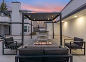 Thumbnail 17 of 19 - the outdoor patio has a fire pit and seating around it at Hamilton Courtyard Apartments, Costa Mesa, CA, 92627