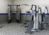 Thumbnail 23 of 27 - A gym with a variety of exercise equipment including a stationary bike, a leg press machine, and a chest press machine.
