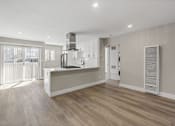 Thumbnail 21 of 64 - a renovated living room and kitchen with white walls and wood floors at Ocean Breeze Terrace Apartment, Huntington Beach