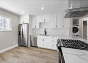 Thumbnail 22 of 64 - a renovated kitchen with white cabinets and stainless steel appliance at Ocean Breeze Terrace Apartment, Huntington Beach, CA, 92648