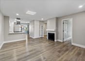 Thumbnail 3 of 64 - a renovated living room with a fireplace and a kitchen at Ocean Breeze Terrace Apartment, California