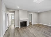 Thumbnail 5 of 64 - Living room with fireplace at Ocean Breeze Terrace Apartment, Huntington Beach, CA