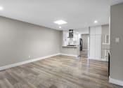 Thumbnail 4 of 64 - an empty room with a hard wood floor and white walls at Ocean Breeze Terrace Apartment, Huntington Beach, California
