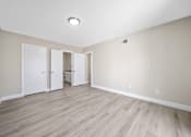 Thumbnail 6 of 18 - an empty living room with wood floors and white walls at Wescove Apartments, West Covina, CA, 91790