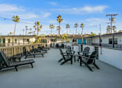 Thumbnail 35 of 64 - Deck with seating and BBQ at Ocean Breeze Terrace Apartment, Huntington Beach, CA