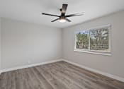 Thumbnail 6 of 14 - an empty bedroom with a window and a ceiling fan at Charle Square Apartments, California