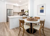 Thumbnail 33 of 34 - A kitchen with a table and chairs. at The Reserve La Mirada, California, 90638