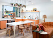 Thumbnail 23 of 34 - A modern kitchen with a white table and orange cabinets. at The Reserve La Mirada, La Mirada