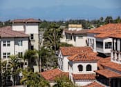 Thumbnail 9 of 10 - A row of houses with red tile roofs.