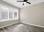 Thumbnail 9 of 10 - an empty bedroom with a ceiling fan and window at Huntington Manor Homes Apartment, Huntington Beach, CA, 92648