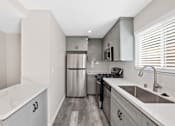 Thumbnail 2 of 19 - Fully Equipped Kitchen at Hamilton Courtyard Apartments, Costa Mesa, CA
