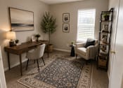 Thumbnail 11 of 38 - A room with a desk, chair, and a couch.