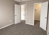 Thumbnail 18 of 38 - A room with carpeted floor and three open doors.
