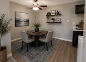Thumbnail 2 of 38 - A dining room with a table, chairs, and a ceiling fan.