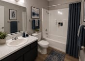 Thumbnail 10 of 38 - A bathroom with a white toilet and a white sink.