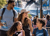 Thumbnail 118 of 128 - A family of four is walking together at the SeaWorld theme park.