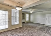 Thumbnail 5 of 16 - A living room with a ceiling fan and window in Arlington, TX.