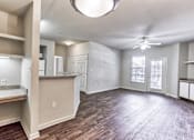 Thumbnail 1 of 16 - A spacious room with a ceiling fan and a large window in Arlington, TX.