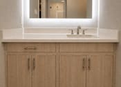 Thumbnail 28 of 52 - A bathroom with a sink and a mirror above it.