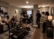 Thumbnail 5 of 52 - A group of people are gathered in a living room.