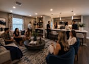 Thumbnail 1 of 52 - A group of people are gathered in a modern living room.