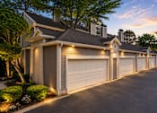 Thumbnail 40 of 52 - A row of houses with garages are shown at dusk.