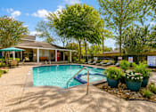 Thumbnail 35 of 52 - A pool with a slide and a house in the background.