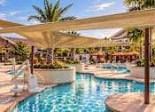 Thumbnail 24 of 128 - A pool area with a sun lounger and a sun shade.