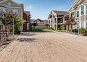 Thumbnail 34 of 128 - A sandy area in front of a row of houses.