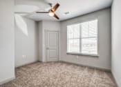 Thumbnail 79 of 128 - A room with a ceiling fan and a window with blinds.